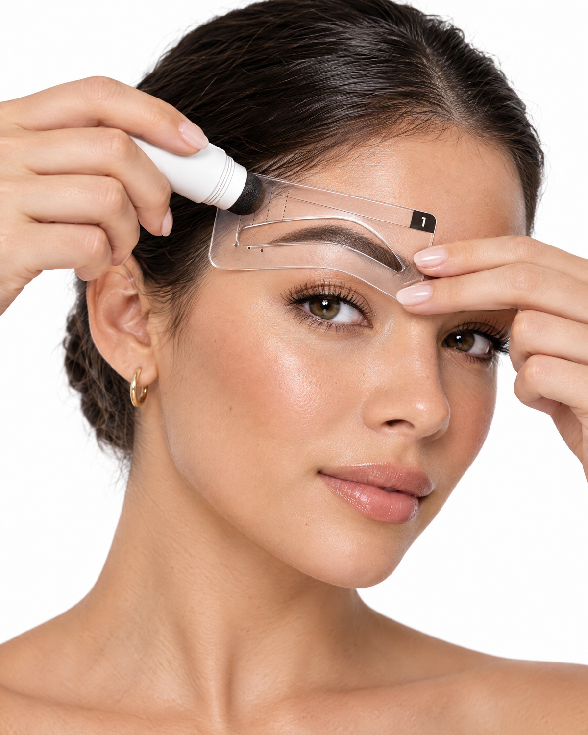 Woman using the Browline brow stamp with a stencil